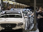 Workers inspect newly assembled cars at a Beijing Benz Automotive Co. Ltd factory, a German joint venture company for Mercedes-Benz, in Beijing on Wednesday, May 13, 2020.