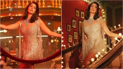 Nora Fatehi is raising the temperature in a stunning golden mini dress embellished with tassels, sequins, and glamorous embroidery. Paired with matching headgear, she looks absolutely breathtaking. (Instagram) Nora Fatehi is raising the temperature in a stunning golden mini dress embellished with tassels, sequins, and glamorous embroidery. Paired with matching headgear, she looks absolutely breathtaking. (Instagram)