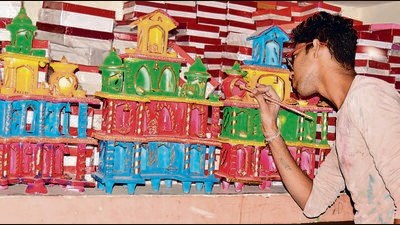 A potter gives finishing touches to clay temples ahead of Diwali, in Ludhiana on Friday. (Manish/HT)