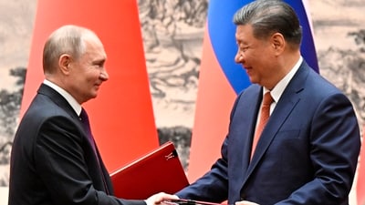 Chinese President Xi Jinping, right, and Russian President Vladimir Putin exchange documents after a signing ceremony during their meeting in Beijing, China. (AP) Chinese President Xi Jinping, right, and Russian President Vladimir Putin exchange documents after a signing ceremony during their meeting in Beijing, China. (AP)
