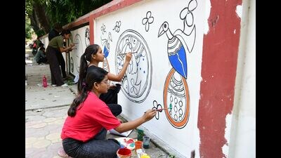 Artistes creating murals on city walls (HT ) Artistes creating murals on city walls (HT )