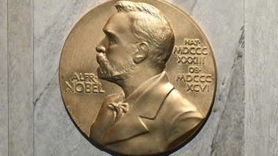 (FILES) This file photo taken on December 10, 2022 shows a plaque showing Swedish chemist, engineer, inventor, businessman, and philanthropist Alfred Nobel (1833-1896) on the podium during preparations ahead of the Nobel Prize award ceremony for literature, science and economy at the Concert Hall in Stockholm, Sweden. (Photo by Jonathan NACKSTRAND / AFP) (AFP) (FILES) This file photo taken on December 10, 2022 shows a plaque showing Swedish chemist, engineer, inventor, businessman, and philanthropist Alfred Nobel (1833-1896) on the podium during preparations ahead of the Nobel Prize award ceremony for literature, science and economy at the Concert Hall in Stockholm, Sweden. (Photo by Jonathan NACKSTRAND / AFP) (AFP)