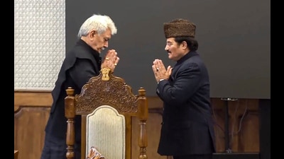 J&K lieutenant governor Manoj Sinha greets the union territory's newly appointed pro tem speaker Mubarak Gul after the latter's oath ceremony at Raj Bhawan in Srinagar on Saturday. (PTI)