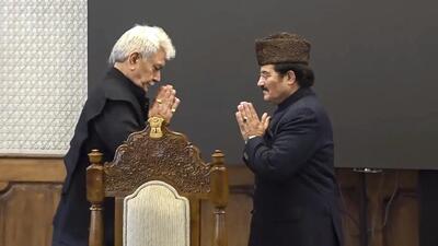 Jammu and Kashmir Lieutenant Governor Manoj Sinha greets the union territory's newly appointed Pro-Tem Speaker Mubarak Gul after the latter's oath ceremony at Raj Bhawan, in Srinagar, Saturda. (PTI)