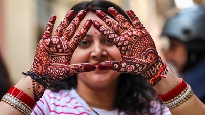 This year, Karwa Chauth will be celebrated on October 20, Sunday, A woman shows her hands decorated with henna, ahead of the Karwa Chauth festival in Jammu on Friday. (PTI) This year, Karwa Chauth will be celebrated on October 20, Sunday, A woman shows her hands decorated with henna, ahead of the Karwa Chauth festival in Jammu on Friday. (PTI)