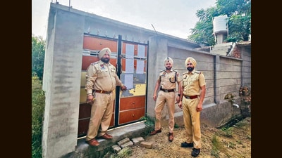 Police paste a seizure notice on the house in Dakha. (HT Photo)