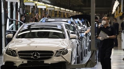 Workers inspect newly assembled cars at a Beijing Benz Automotive Co. Ltd factory, a German joint venture company for Mercedes-Benz, in Beijing on Wednesday, May 13, 2020. (AP)