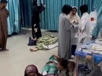 Palestinians wounded in Israeli strikes lie on the ground at Kamal Adwan hospital.
