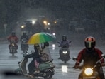 Commuters move amid rainfall at Cubbon Road, in Bengaluru. Commuters move amid rainfall at Cubbon Road, in Bengaluru.