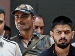 Policemen escort Lawrence Bishnoi in New Delhi in April 2023. (Reuters)