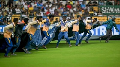 Groundsmen cover the field as it rains during the fourth day play of the first Test cricket match between India and New Zealand at the M. Chinnaswamy Stadium in Bengaluru on October 19, 2024. (AFP) Groundsmen cover the field as it rains during the fourth day play of the first Test cricket match between India and New Zealand at the M. Chinnaswamy Stadium in Bengaluru on October 19, 2024. (AFP)