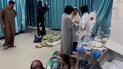 Palestinians wounded in Israeli strikes lie on the ground at Kamal Adwan hospital. (REUTERS)