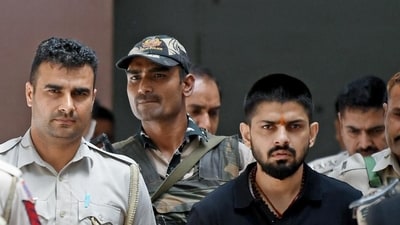 Policemen escort Lawrence Bishnoi in New Delhi in April 2023. (Reuters) Policemen escort Lawrence Bishnoi in New Delhi in April 2023. (Reuters)