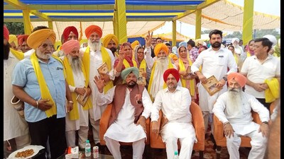 Punjab cabinet minister Kuldeep Singh Dhaliwal with newly elected panches and sarpanches from the Ajnala constituency during an event in Amritsar on Sunday. (HT photo)
