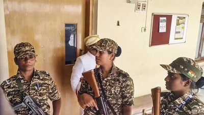 Security personnel stand guard during a raid by the Enforcement Directorate on the Mysuru Urban Development Authority (MUDA) office in connection with a money laundering case in Mysuru on Friday. (PTI) Security personnel stand guard during a raid by the Enforcement Directorate on the Mysuru Urban Development Authority (MUDA) office in connection with a money laundering case in Mysuru on Friday. (PTI)