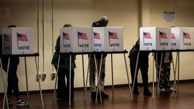 Voters cast their ballots during the first day of early voting at a polling station in Detroit, Michigan, on Saturday. (Bloomberg) Voters cast their ballots during the first day of early voting at a polling station in Detroit, Michigan, on Saturday. (Bloomberg)