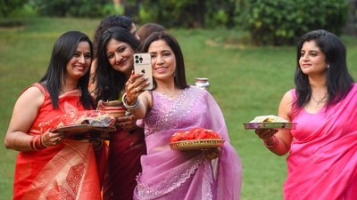 A group of women, all decked out in sarees and jewellery, pose for a selfie while holding their Karwa Chauth thalis. (Photo by Parveen Kumar/Hindustan Times) A group of women, all decked out in sarees and jewellery, pose for a selfie while holding their Karwa Chauth thalis. (Photo by Parveen Kumar/Hindustan Times)