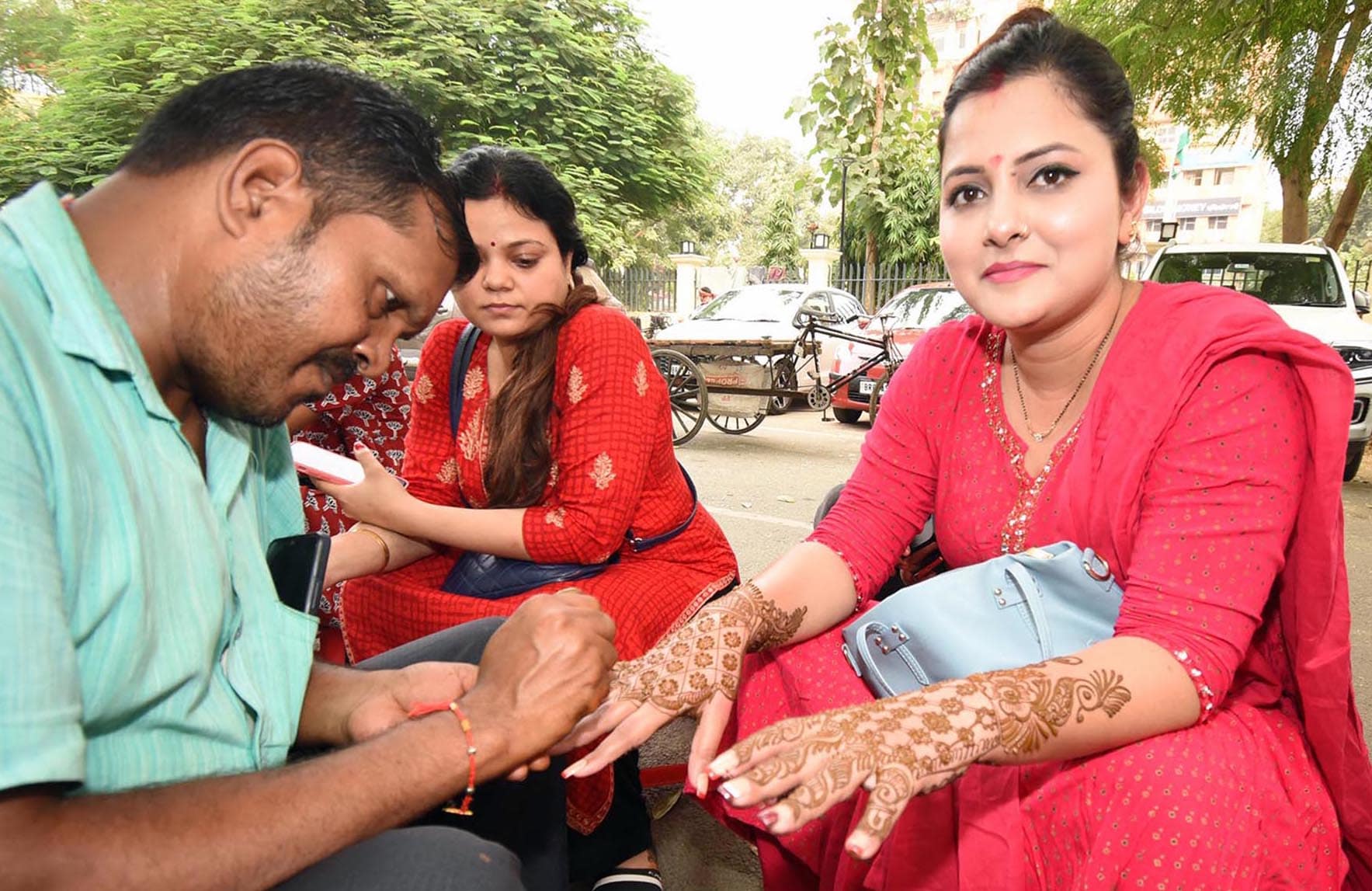 Women apply mehndi on the eve of Karwa-Chauth festival at Maurya Lok Complex in Patna, Bihar.