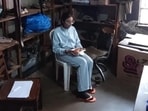 Vasundhara Oswal sits among shoes while detained in Uganda. 