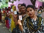 Voters show their ID cards before casting their ballot.(HT Photo)