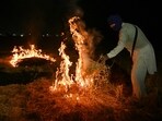 A farmer burns straw stubble after a harvest, at a paddy field on the outskirts of Amritsar A farmer burns straw stubble after a harvest, at a paddy field on the outskirts of Amritsar