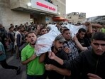 Palestinians mourn as they carry the bodies of relatives killed in the Israeli bombardment of the Gaza Strip at a hospital in Deir el-Balah, Sunday, Oct. 20, 2024.