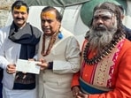 Reliance Industries Chairman Mukesh Ambani gives a cheque of Rs. 5.02 crore to Badarinath-Kedarnath Temple Committee President Ajendra Ajay. Reliance Industries Chairman Mukesh Ambani gives a cheque of Rs. 5.02 crore to Badarinath-Kedarnath Temple Committee President Ajendra Ajay.