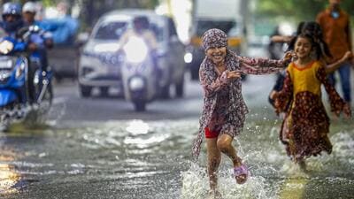 Children play on a waterlogged road after heavy rain in Bengaluru on Monday. (PTI) Children play on a waterlogged road after heavy rain in Bengaluru on Monday. (PTI)