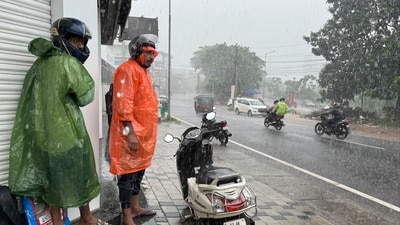 Two men who were riding a two-wheeler take shelter outside a closed shop during a heavy rain in Kochi, southern Kerala state, India. (AP Photo/ R S Iyer) Two men who were riding a two-wheeler take shelter outside a closed shop during a heavy rain in Kochi, southern Kerala state, India. (AP Photo/ R S Iyer)