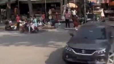 The video, recorded on Saturday evening, shows a grey Baleno being driven without any registration number, and a black film covering its glass windows drifting in a busy Alpha 2 market of the city. (Screen grab) The video, recorded on Saturday evening, shows a grey Baleno being driven without any registration number, and a black film covering its glass windows drifting in a busy Alpha 2 market of the city. (Screen grab)