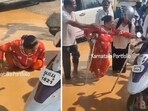 Bengaluru rain: The image shows passersby helping a physically challenged woman who fell in a waterlogged street. Bengaluru rain: The image shows passersby helping a physically challenged woman who fell in a waterlogged street.