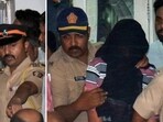 Police personnel escort the two accused -- Gurmail Singh and Dharamraj Kashyap -- to be produced at Esplanade Court in Mumbai.