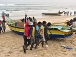 Fishermen shift their boats in anticipation of Cyclone Dana in Odisha’s Puri on Monday. (PTI) Fishermen shift their boats in anticipation of Cyclone Dana in Odisha’s Puri on Monday. (PTI)