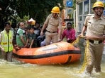 Rescue workers move stranded residents of an apartment in a boat after it was flooded due to heavy rains in Bengaluru on Tuesday. Rescue workers move stranded residents of an apartment in a boat after it was flooded due to heavy rains in Bengaluru on Tuesday.