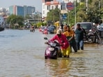 Commuters push their two-wheelers through a waterlogged road after heavy rain, near Kendriya Vihar apartment in Bengaluru on Tuesday. Commuters push their two-wheelers through a waterlogged road after heavy rain, near Kendriya Vihar apartment in Bengaluru on Tuesday.