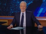 Jon Stewart critiques the media's trivialization of Trump's comments, urging vigilance as he recalls the Capitol insurrection, underscoring the seriousness of Trump's past actions.
