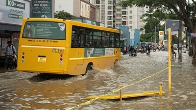 A school bus moves through a flooded road after heavy rains in Bengaluru. (REUTERS)