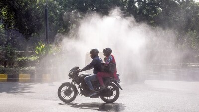Commuters pass by as an anti-smog vehicle sprinkles water to curb air pollution amid deteriorating air quality, in New Delhi. (ANI file) Commuters pass by as an anti-smog vehicle sprinkles water to curb air pollution amid deteriorating air quality, in New Delhi. (ANI file)