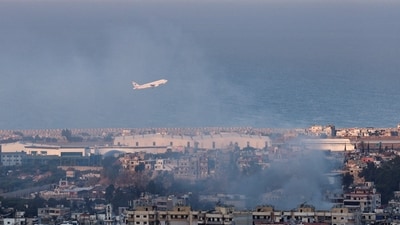 A Lebanese Middle East Airlines (MEA) plane takes off from Beirut-Rafic Hariri International Airport as smoke billows, amid the ongoing hostilities between Hezbollah and Israeli forces, in Beirut, Lebanon October 22. (REUTERS)