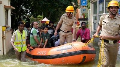 Rescue workers move stranded residents of an apartment in a boat after it was flooded due to heavy rains in Bengaluru on Tuesday. (AP) Rescue workers move stranded residents of an apartment in a boat after it was flooded due to heavy rains in Bengaluru on Tuesday. (AP)