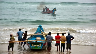 Fishermen shift their boats in preparations for Cyclone Dana in Puri on Monday. (PTI) Fishermen shift their boats in preparations for Cyclone Dana in Puri on Monday. (PTI)