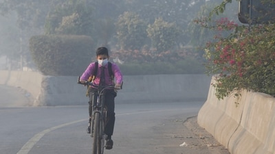Student rides a bicycle to school amid dense smog in Lahore. (Reuters)