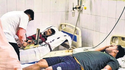 People being treated in a hospital in Saran, Bihar, after they consumed suspected spurious liquor last Wednesday. (PTI) People being treated in a hospital in Saran, Bihar, after they consumed suspected spurious liquor last Wednesday. (PTI)