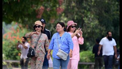 Tourists enjoying a leisurely stroll at the Sukhna Lake in Chandigarh on Tuesday. (Ravi Kumar/HT)