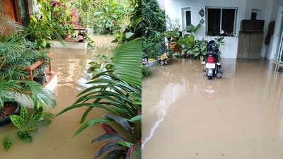 Rainwater floods a bungalow in Bengaluru, submerging the garden and leaving a parked vehicle partially underwater.&nbsp; (X/JDS)