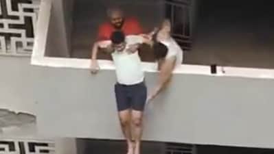The man was pulled back in by residents (Screengrab from video) The man was pulled back in by residents (Screengrab from video)