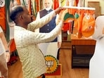 A shopkeeper prepares election campaign material for political parties in Nagpur on Tuesday. (ANI Photo)