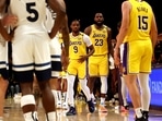 James (23) checks into the game with his son, guard Bronny James (9) during the second quarter against the Minnesota Timberwolves at Crypto.com Arena. This marked the first time in NBA history that a father and son played together. Mandatory Credit: Jason Parkhurst-Imagn Images