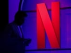 A man stands next to a logo of Netflix during an event in Mumbai, India, February 29, 2024.