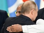 Russia's President Vladimir Putin and Prime Minister Narendra Modi embrace at the end of the extended format meeting of the BRICS summit.